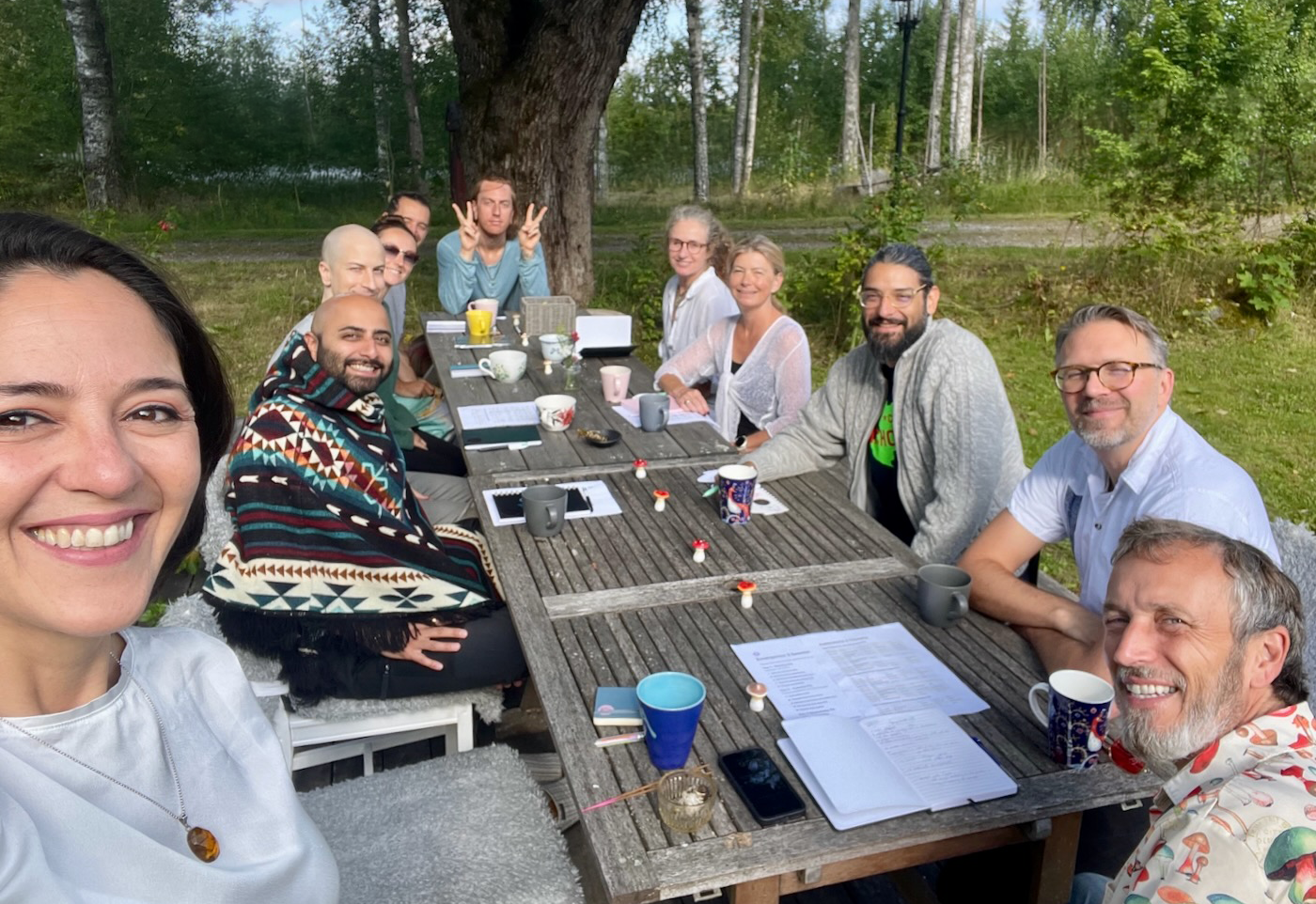 Workshop in progress at Mycelium Hub — group gathered around an outdoor table in the Värmland forest.